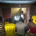 Jean-Francis Kyelem, Koupela, quartier Rondin. Burkina Faso. policier de son Il a monté un club vidéo devant sa maison depuis qu'il a acheté un kit solaire.